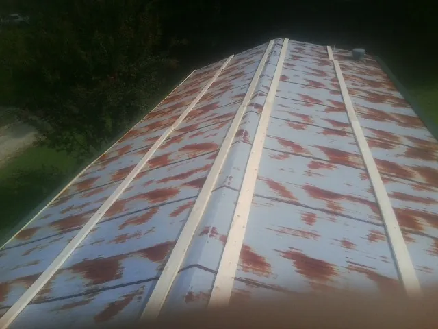 Rusted metal roof panels with new wood purlins before replacement — Storm Damage Roof Repair in Cut Off by Roofing Brothers